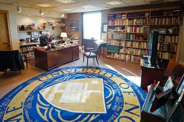 Fr. Hesburgh sitting at the desk in his office in 2013